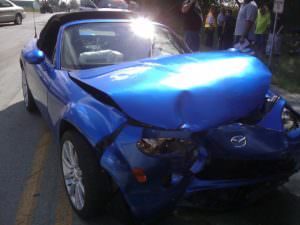 picture of blue convertible with smashed front end