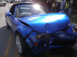 picture of a blue convertible with a smashed front end