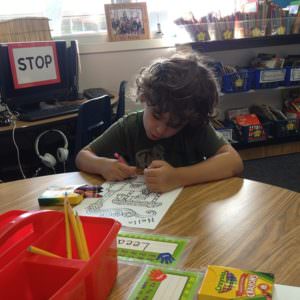 picture of a child coloring in a classroom
