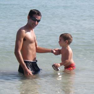 father and son in shallow water