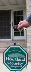 picture of a key fob with a Heartland Security yard sign