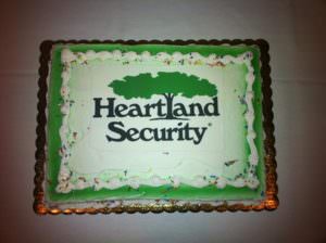 picture of cake with Heartland Security logo