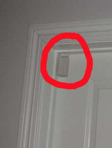 picture of a red circle around a white door sensor on a white door with a white door frame