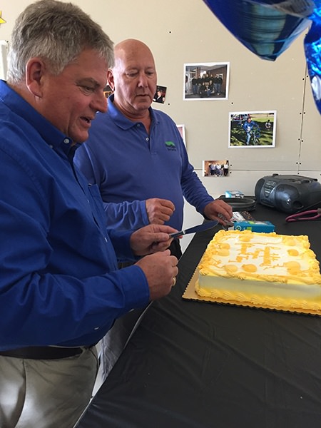 picture of Tom and Guy getting ready to cut the cake