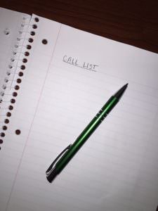 picture of a green pen and notebook with the words "Call List"