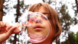 girl blowing bubbles