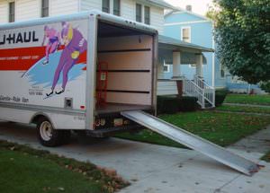 picture of a U-Haul truck with a ramp down in a driveway