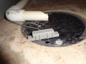 Gray water sensor sitting on floor drain