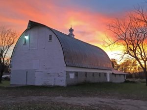 picture of a barn at sunset