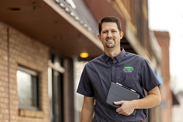 picture of Nate Ellis holding a tablet walking down the street