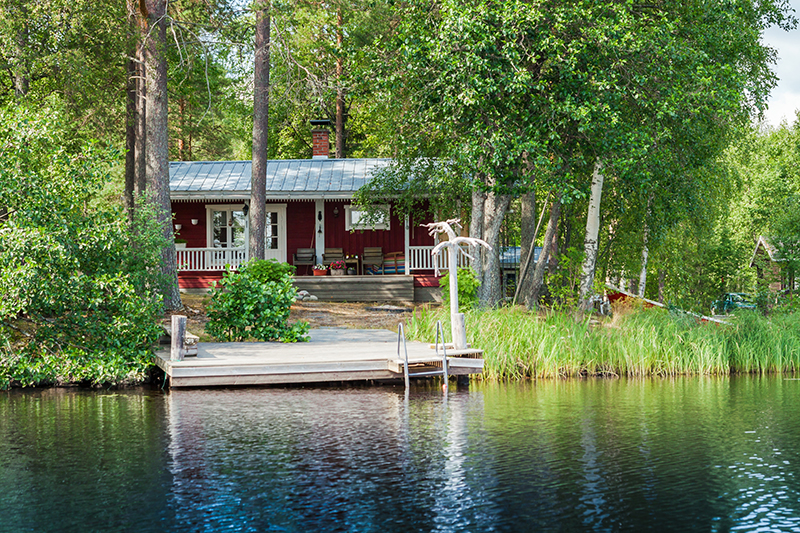 picture of a cabin with small dock on a lake