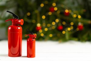 fire extinguishers in front of christmas tree with twinkle lights