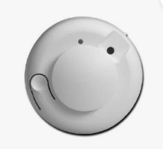 A circle-shaped, white security alarm unit